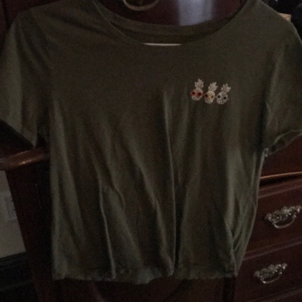 Army green top with pineapple decal in top left